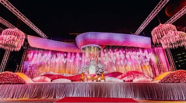 Pink floral wedding stage by EMC Events
